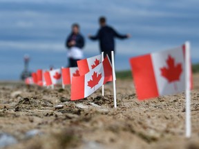 Canadian flags are planted in the sand of Juno Beach in Courseulles-sur-Mer, western France, on June 4, 2019, during preparations for the celebration of the 75th anniversary of D-Day.