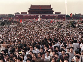 Thousands of Chinese gather around a replica of the Statue of Liberty, called the Goddess of Democracy, in Tiananmen Square demanding democracy  in 1989.