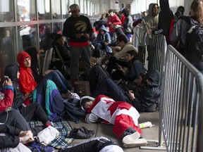 Toronto Raptors fans line up outside the Scotiabank Arena, in Toronto on Monday, June 10, 2019, to gain access to the fan area known as 'Jurassic Park' ahead of game five of the NBA Finals between the Toronto Raptors ad Golden State Warriors.