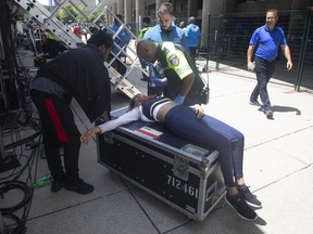 A woman is treated by a paramedic after being pulled from the crowd during the 2019 Toronto Raptors Championship parade in Toronto, on Monday, June 17, 2019.