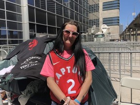 Angie Taylor, 33, from Cambridge, Ont., lines up at Jurassic Park by Scotiabank Arena in Toronto, Saturday, June 8, 2019. Die-hard Toronto Raptors fans are lining up days in advance for a spot in the outdoor fanzone known as Jurassic Park for Game 5 of the NBA Finals on Monday night.