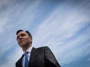 Federal Minister of Finance Bill Morneau arrives for a news conference in Vancouver on June 13, 2019. A government-struck expert panel is calling for new "super-deduction" tax credits as a carrot for Canadians to park their retirement savings in climate-conscious investments. The report this morning to Finance Minister Bill Morneau says the government should allow people to deduct more than 100 per cent of retirement contributions that are in bonds, for instance, that help reduce greenhouse gas emissions.