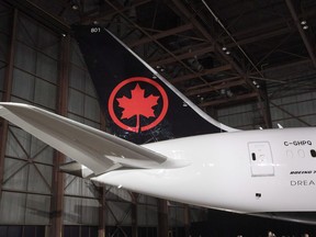 The tail of the newly revealed Air Canada Boeing 787-8 Dreamliner aircraft is seen at a hangar at the Toronto Pearson International Airport in Mississauga, Ont., Thursday, February 9, 2017. Aviation experts are raising security and passenger safety concerns after a woman was left sleeping on a taxied Air Canada flight with the lights turned off and crew gone.