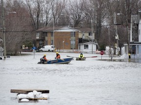 People use boats along Rue Saint-Louis in Gatineau, Que. as flooding from the Ottawa River continues to affect the region on Saturday, April 27, 2019. Canada can do a better job of protecting homeowners from the escalating financial risks of flooding, according to a new report authored by the Insurance Bureau of Canada.