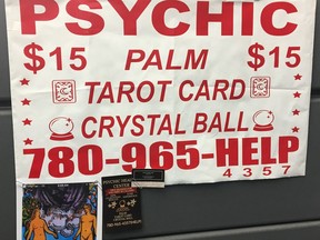 A sign advertising palm, tarot card and crystal ball reading is shown in this handout image. Edmonton police say there is nothing magic about a woman accused of bilking 10 people of money with a promise that a special crystal would improve their lives.