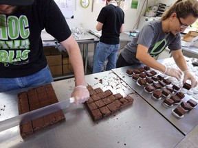 Smaller-dose pot-infused brownies are divided and packaged at The Growing Kitchen in Boulder, Colo. on Sept. 26, 2014. Canadians looking to enjoy soon-to-be-legalized pot-infused edibles could get hit with higher insurance premiums -- depending on the size of their appetite.