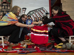 Commissioners Marion Buller (left) and Commissioner Michele Audette prepare the official copy of the report for presentation to the government during ceremonies marking the release of the Missing and Murdered Indigenous Women report in Gatineau June 3, 2019.