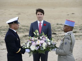 Prime Minister Justin Trudeau takes part in a wreath laying ceremony as part of the D-Day 75th Anniversary International French Commemorative Ceremony at Juno Beach in Courseulles-Sur-Mer, France on Thursday, June 6, 2019. Trudeau is concluding his trip to France today, where he took part in marking the 75th anniversary of D-Day.