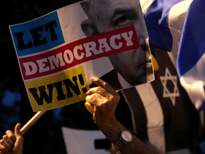 An Israeli demonstrator take part in a rally against Prime Minister Benjamin Netanyahu outside his Jerusalem residency on May 30, 2019.