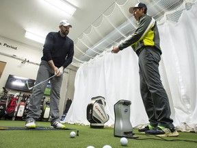 Carson Hau (right), Director of Technology at The Golf Lab, and student Matthew Parkinson practice during a training session at The Golf Lab in King City, Ontario on Saturday May 4, 2019.