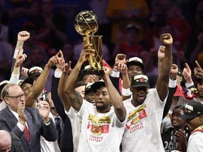 Toronto Raptors forward Kawhi Leonard, centre, holds Larry O'Brien NBA Championship Trophy after defeating the Golden State Warriors basketball action in Game 6 of the NBA Finals in Oakland, Calif. on Thursday, June 13, 2019. Raptors have won their first NBA title in franchise history.