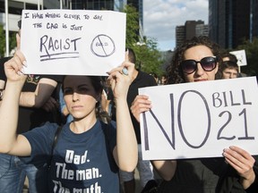 People attend a demonstration to protest against the Quebec government's Bill 21 in Montreal, Monday, June 17, 2019.