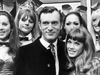 Hugh Hefner on a visit to a London Playboy club in 1969, with his 19-year-old girlfriend Barbara Benton and a group of Playboy Bunnies.