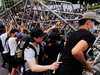 Demonstrators attempt to move metal barricades during a protest against a proposed extradition bill in Hong Kong in Hong Kong, China June 12, 2019.