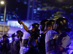 Riot police officers stand guard outside the Legislative Council during a protest to demand authorities scrap a proposed extradition bill with China in Hong Kong, China, early June 10, 2019.