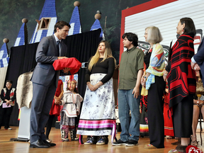 Prime Minister Justin Trudeau is presented with the final report during the closing ceremony of the National Inquiry into Missing and Murdered Indigenous Women and Girls in Gatineau, Quebec, June 3, 2019.