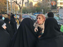 A woman without a hijab is confronted by Iran's 