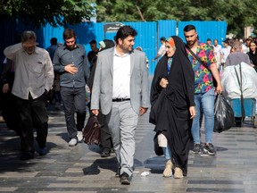 People walk on a shopping street called the Grand Bazzar in downtown of Tehran, Iran June 23, 2019.