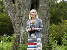 Minister of Environment and Climate Change Catherine McKenna holds a sapling that she received after making an announcement, on World Environment Day at the Dominion Arboretum in Ottawa on Wednesday, June 5, 2019.