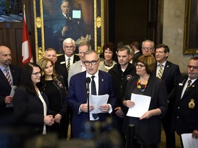 Liberal MP Neil Ellis is joined by Conservative MP Cathay Wagantall, left, NDP MP Sheri Benson, second from right, and members of advocacy groups during a press conference on his motion M-225, which calls on the federal government to set a goal of ending veteran homelessness with a plan and deadlines, in the Foyer of the House of Commons on Parliament Hill in Ottawa on Wednesday, June 5, 2019.