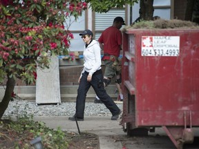 A member of a security firm is seen outside the home of Huawei executive Meng Wanzhou in Vancouver, Thursday, June 6, 2019.