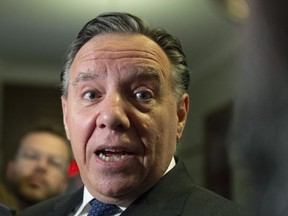 Quebec Premier Francois Legault responds to reporters questions over his meeting with Alberta Premier Jason Kenney, Wednesday, June 12, 2019 at the legislature in Quebec City.