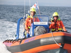 Erick Busnel, left, drives a lifeboat with fellow volunteer Gilles Deschamps at Juno Beach in Normandy, France.