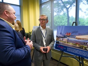 Damien de Roux, the general manager of the current Gateway casino talks with Grant Darling, the VP of gaming operations for Gateway Casino at the London Chamber of Commerce. They were at the official unveiling of the sketches for Gateway Casino's new casino to be built on Wonderland Road. (Mike Hensen/The London Free Press)