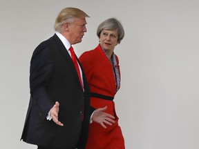 FILE - In this Friday, Jan. 27, 2017 file photo, President Donald Trump and British Prime Minister Theresa May walk along the colonnades of the White House in Washington. During his state visit starting June 3, 2019, Trump will meet with Prime Minister Theresa May as her authority is fading. Trump professes friendship for May, but he has been harshly critical of her handling of the tortured Brexit negotiations, and has buddied up to Boris Johnson, who hopes to follow May to power, and Brexit party leader Nigel Farage, who accuses May of incompetence and betrayal.