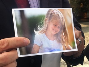 Gabe Batstone holds a photo of his daughter Teagan outside of New Westminster Law Courts on Wednesday, June 12, 2019. The father of an eight-year-old girl who was smothered by her mother says a happy, empathetic, sensitive and loving child was taken away from the world for no reason. Gabe Batstone told a British Columbia Supreme Court judge at Lisa Batstone's sentencing hearing that the worst part has been seeing the impact on her two young half-brothers, who live with "profound grief."