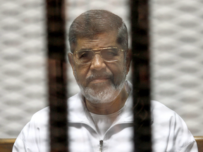 Former Egyptian President Mohamed Mursi behind bars during his trial at a Cairo court in May 2014.