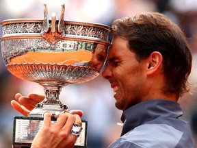 Rafael Nadal of Spain celebrates with the trophy following the mens singles final against Dominic Thiem of Austria during Day fifteen of the 2019 French Open at Roland Garros on June 09, 2019 in Paris, France.