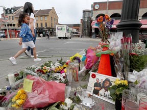 Flowers at the corner of York Street and ByWard Market Square in Ottawa pay tribute to Markland "Jahiant" Campbell, a father and a member of the hip-hop trio HalfSizeGiants, who was fatally shot on June 7, 2019.
