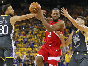 Toronto Raptor Kawhi Leonard to the basket against Stephen Curry and Klay Thompson of the Golden State Warriors during Game 4 of the NBA Finals.
