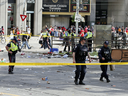 Police investigate the scene after a shooting during the Toronto Raptors victory parade on June 17, 2019.