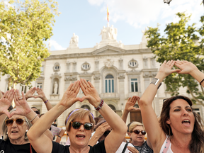 Women gather outside the Supreme Court after Spain's top court found five men known as the "Wolf Pack" guilty of rape in Madrid, Spain, June 21, 2019.