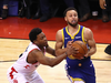 Stephen Curry of the Golden State Warriors is defended by Toronto Raptor Kyle Lowry during Game 2.