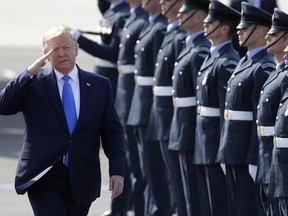 President Donald Trump salutes an honor guard as he and first lady Melania Trump arrive at Stansted Airport in England, Monday, June 3, 2019 at the start of a three day state visit to Britain.