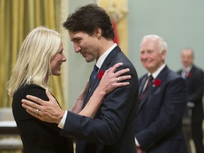 Prime Minister Justin Trudeau hugs newly sworn-in Environment Minister Catherine McKenna at Rideau Hall in Ottawa in a file photo from Nov. 4, 2015.