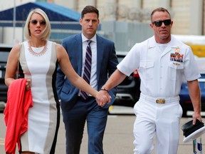 U.S. Navy SEAL Special Operations Chief Edward Gallagher arrives at court with his wife Andrea and brother Sean (C) for the start of his court-martial trial at Naval Base San Diego in San Diego, California, U.S., June 18, 2019.