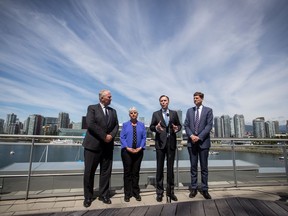 Federal Minister of Finance Bill Morneau, third left, speaks as Federal Minister of Border Security and Organized Crime Reduction Bill Blair, from left to right, B.C. Finance Minister Carole James and B.C. Attorney General David Eby listen during a news conference after attending a meeting about money laundering and terrorist financing, in Vancouver, on Thursday June 13, 2019.
