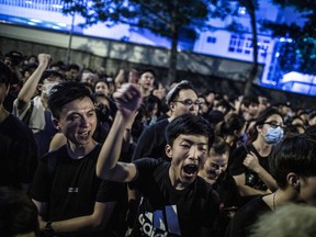 Protesters chant while gathering outside of the Office of the Chief Executive during a rally in Hong Kong, China, on Sunday, June 16, 2019. Tens of thousands of demonstrators poured into central Hong Kong as organizers remained defiant even after the city's leader suspended consideration of the China-backed extradition plan that sparked some of the biggest protests in the city in decades.