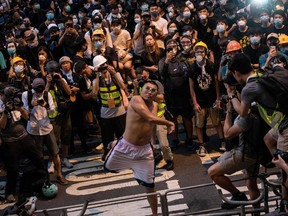 A protester throws an egg at the police headquarters in Hong Kong on June 21, 2019. - Thousands of protesters converged on Hong Kong's police headquarters on June 21, demanding the resignation of the city's pro-Beijing leader and the release of demonstrators arrested during the territory's worst political crisis in decades.