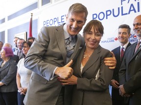 People's Party of Canada Leader Maxime Bernier poses for a photo with candidate Renata Ford, the former wife of the late Toronto mayor Rob Ford, at an announcement in Toronto on Friday, June 21, 2019.