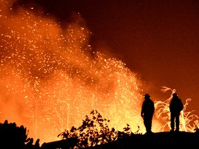 Firefighters keep watch on the Thomas wildfire in the hills and canyons outside Montecito, California, U.S., December 16, 2017.