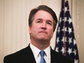 In this file photo taken on October 8, 2018 Brett Kavanaugh waits before being sworn-in as Associate Justice of the US Supreme Court  in the East room of the White House  in Washington, DC. - The US Supreme Court is supposed to be a sacred institution impervious to partisan politics but the newly confirmed justice Brett Kavanaugh gives the court its staunchest conservative majority in decades. As he was sworn in Monday night at the White House, after an ugly, contentious Senate confirmation process in which he battled allegations of sexually assaulting women, Kavanaugh, 53, vowed to serve the country -- not one political party or another."The Supreme Court is an institution of law. It is not a partisan or political institution," said Kavanaugh, who was to take up his seat on the nine-member bench on October 9, 2018. (Photo by Jim WATSON / AFP)JIM WATSON/AFP/Getty Images