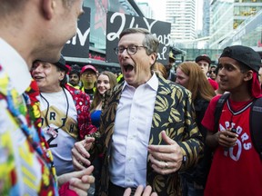 Toronto Mayor John Tory meets with Toronto Raptors fans in his gold Raptors jacket before the NBA Finals Game 4 against the Golden State Warriors held outside of the Scotiabank Arena at Jurassic Park in Toronto, Ont. on Friday June 7, 2019.