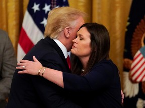 U.S. President Donald Trump embraces White House Press Secretary Sarah Sanders after it was announced she will leave her job at the end of the month during an event at the White House in Washington, U.S., June 13, 2019.