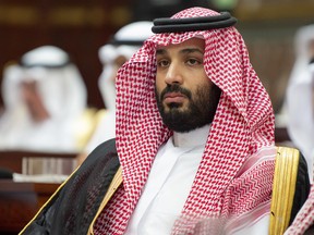 A handout picture provided by the Saudi Royal Palace on November 19, 2018, shows Saudi Arabia's Crown Prince Mohammed bin Salman attending a speech given by his father, King Salman bin Abdulaziz while addressing the Shura council, a top advisory body, in the capital Riyadh.