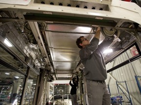 Piotr Job, right, and Sabino Iacobucci work on a Toronto streetcar under construction at the Bombardier factory in Thunder Bay, Ont., in a file photo from Dec. 3, 2014.